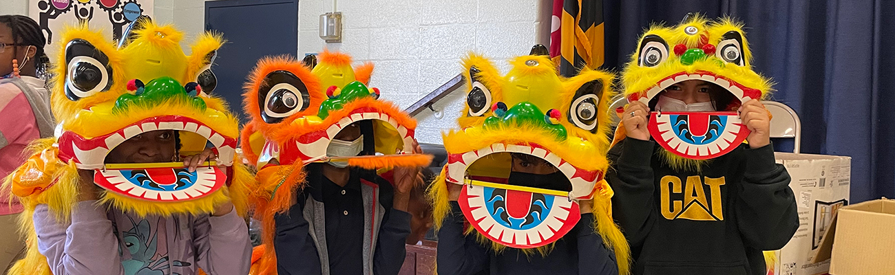 H-students-in-Chinese-lion-masks-celebrating-Chinese-New-Year.jpg